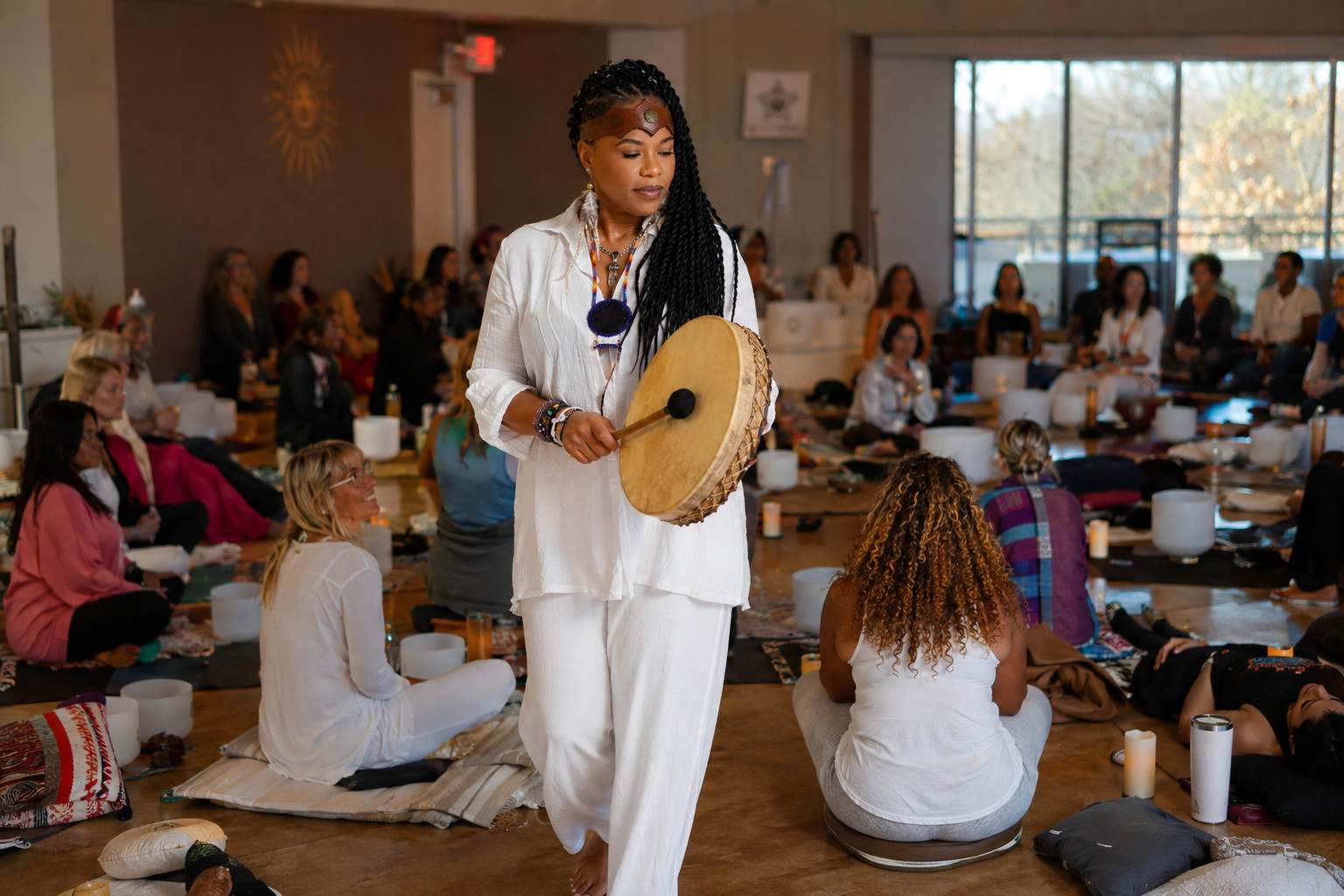 Shaman Yawna Shakti facilitating a large group sound healing session in Chicago