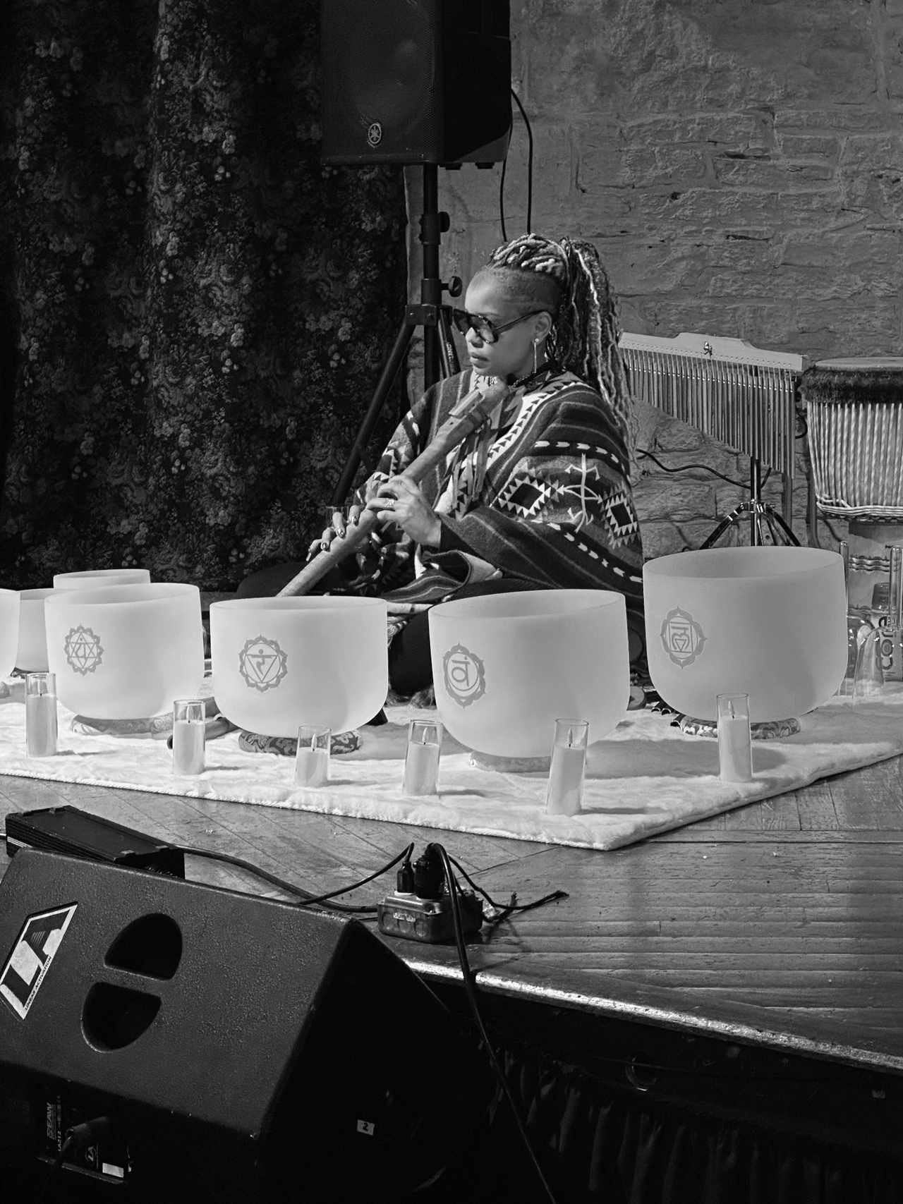 Shaman Yawna Shakti facilitating a live sound bath on stage